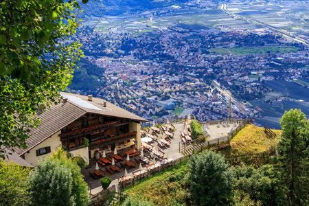 Mountain inn Hochmuth with terrace and panorama of Merano in South Tyrol, Italyの写真素材
