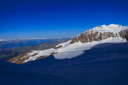 Mountain glacier panorama with summit Castor (foreground) and Mont Blanc massif (background) in the morning in Pennine Alps, Italyの写真素材