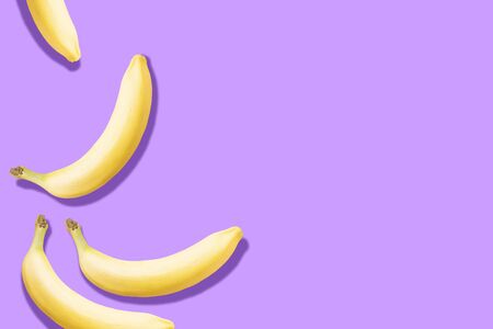 pattern of bananas with prominent shadow on pastel purple background with copy spaceの写真素材