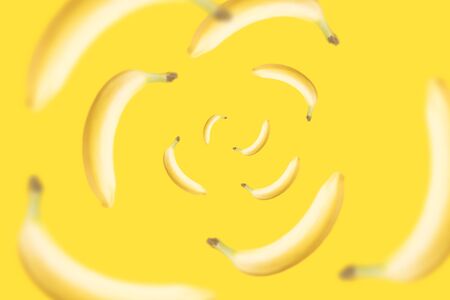 yellow bananas flying on bright background levitation trendの写真素材