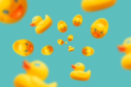 levitating yellow rubber ducks on a turquoise blue backgroundの写真素材