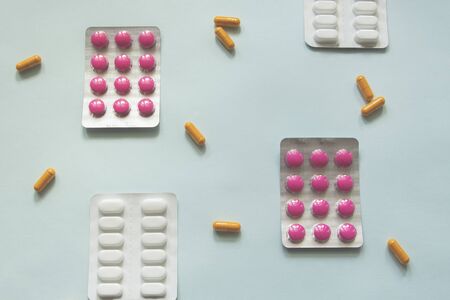 various antipyretics medicine on blue background, flu seanon or coronavirus concept