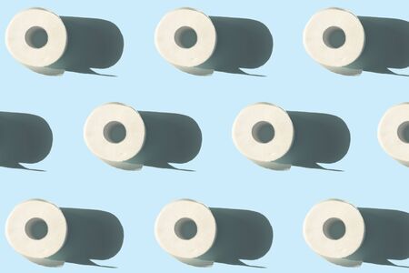quarantine concept toilet paper rolls with shadow pattern on blue backgroundの写真素材