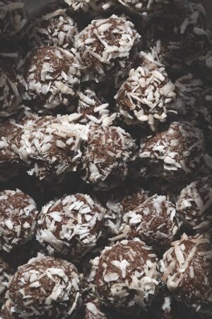 close up of home made low carb coconut balls made with pecan and macadamia nut butter and dark chocolateの写真素材