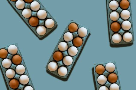 egg cartons pattern on a blue background Easter trendy stylish backdropの写真素材