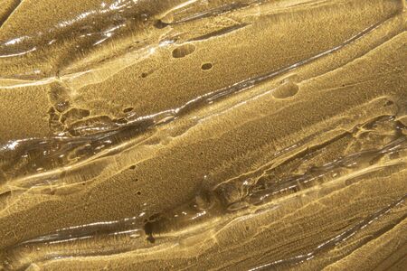 transparent gel texture on gold metallic background luxury beauty treatmentの写真素材