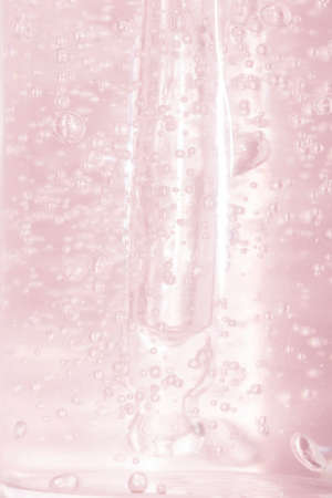 soft focus vertical background detail of a pipette with oxygen bubbles toned pink