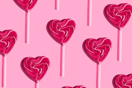 pink red heart shape lollipop pattern on a pink background
