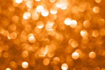 blurred bokeh of glitter festive background for your project toned marigold colorの写真素材