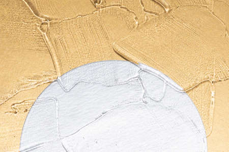 Luxury beauty serum texture on golden metallic background with silver geometric details with...