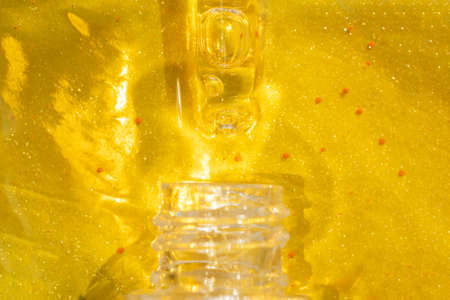 macro of pipette with liquid face serum on gold background luxury skin care treatment concept