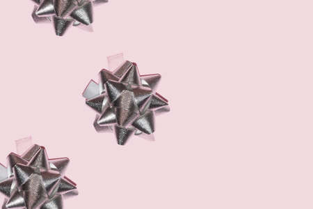 silver metallic star ribbon on a pastel pink background for christmas backdrop