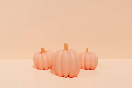 3d render of orange pumpkins on a pastel orange background for Halloweenの写真素材