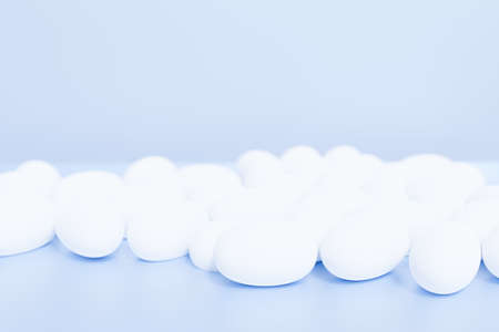 3d render of white pills for your project on a blue background with copy spaceの写真素材