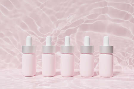 3d render of pink face serum pipette bottles on a pink water background for your beauty projectの写真素材