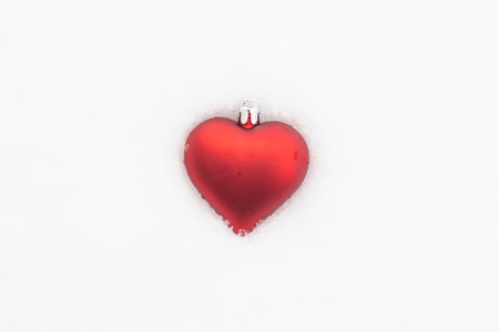 Heart shape Christmas bauble in snow for Valentines Day projectの写真素材