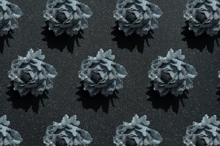 Christmas silver glitter rose ornament pattern on a black glitter background for a Christmas projectの写真素材