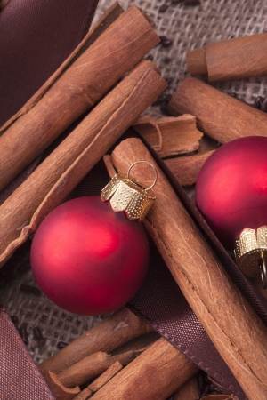 red Christmas tree ornaments and cinnamon sticksの写真素材