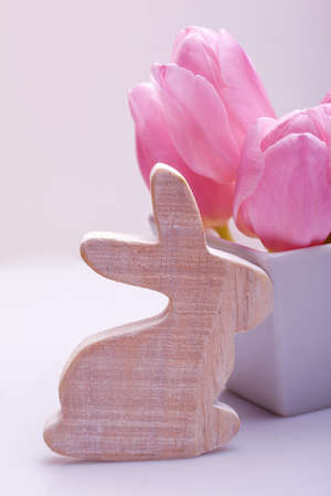 easter decoration with wooden bunny and pink tulip in a boxの写真素材