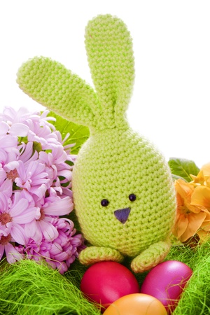 handmade easter bunny with colorful flowers and easter eggsの写真素材