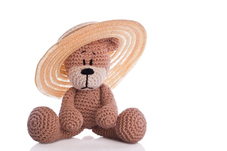 brown teddy bear with sun hatの写真素材