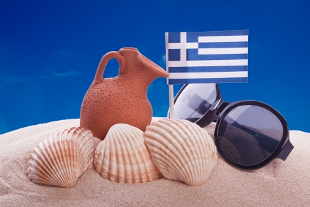 amphora and greece flag on a beachの写真素材