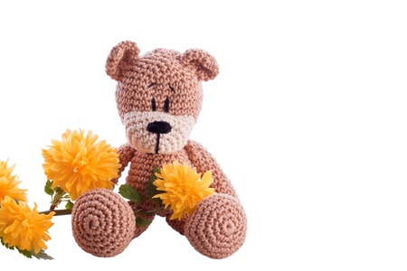 brown teddy bear with yellow blossom flower