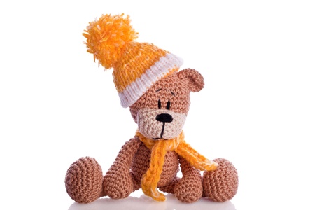 teddy bear with  scarf and bobble cap in winter