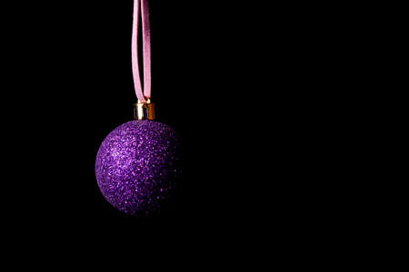 pink christmas ball decoration on black backgroundの写真素材