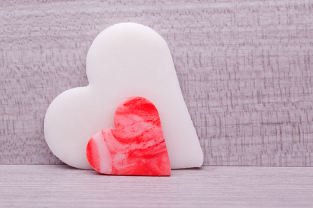 Two hearts on wooden background の写真素材