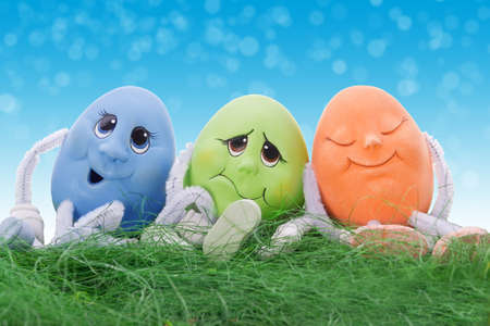 a group of easter eggs sit on grass の写真素材