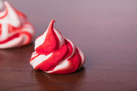 sweet handmade white red meringue swirlsの写真素材