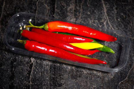 Different chili on a stone plateの写真素材