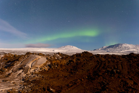 Aurora borealis, northern lights over the mountains in Icelandの写真素材