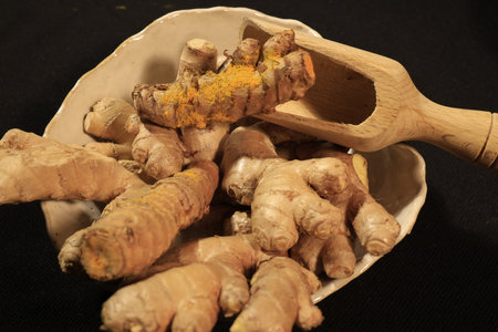 Ginger and Turmeric Roots on a dark background