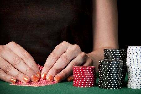 woman checking cards on texas holdemのeditorial素材