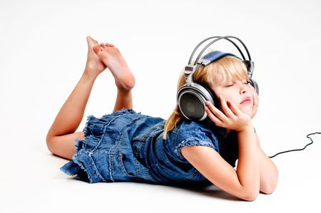 Young girl listen to music in headphones on white backgroundの写真素材