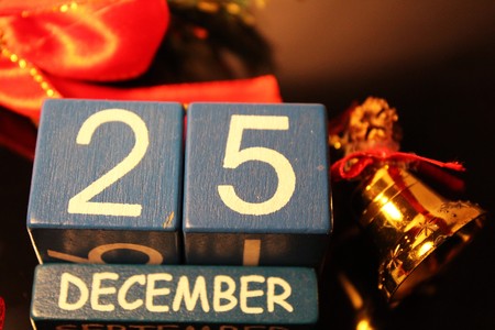 Date cubes and red ribbon with bellの写真素材