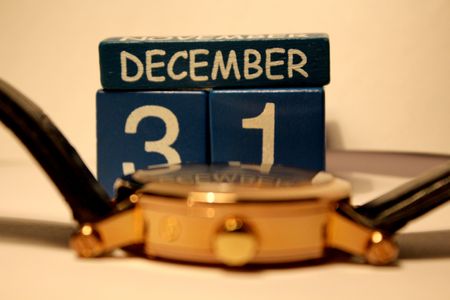 Wooden date cubes and defocused golden hand watch  macro  の写真素材