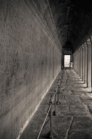 Siem Reap, Cambodia: Angkor Wat Temple: young people study the inscriptions of the stone carvingのeditorial素材