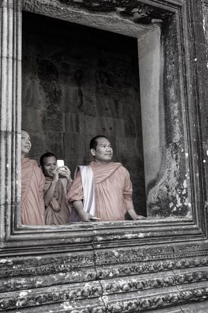 Siem Reap, Cambodia: Angkor Wat Temple: Monks look expectantly into the courtyard of the inner sanctuaryのeditorial素材