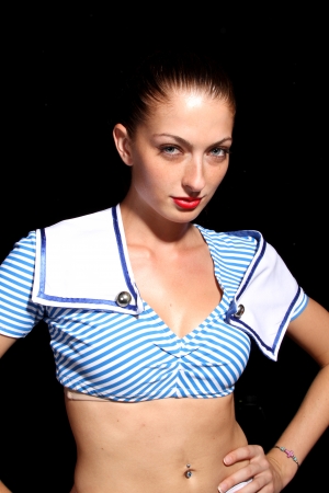 Seductive young brunette posing on a black backgroundの写真素材