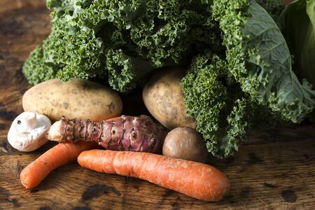 Selection of fresh vegetables on an old wooden tableの写真素材
