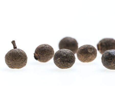 Composition of whole allspice isolated on white backgroundの写真素材