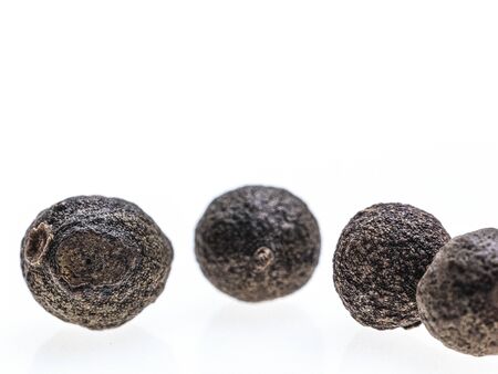 Closeup of pile of allspice seeds on white backgroundの写真素材