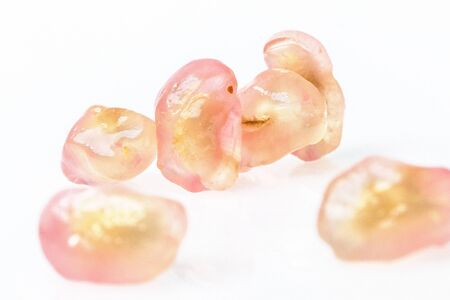 Many seeds of pomegranate on pile on white backgroundの写真素材