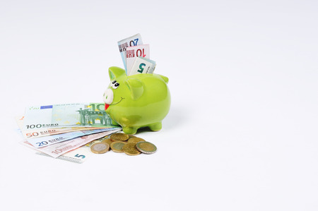 Piggy bank with Euro bills and Euro Coinsの写真素材