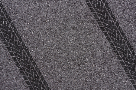 Tire tread marks on asphalt backgroundの写真素材