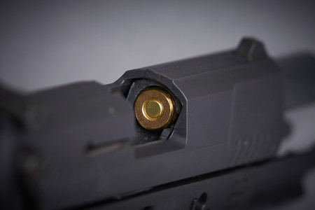 bullet in the chamber of a handgunの写真素材