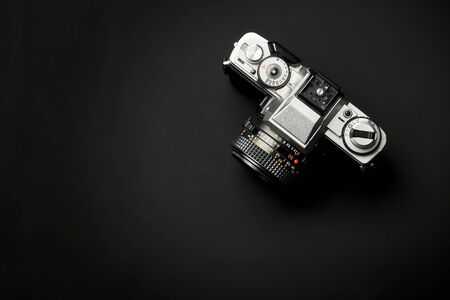 top view of a Classic analog 35 mm camera vintage on black table backgroundの写真素材